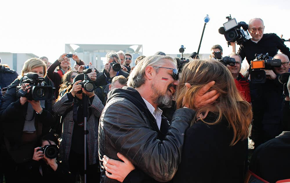 Demonstrators kiss and hug each other during a so called 'kiss-marathon' for German-Greek solidarity prior to a bilateral meeting of German Chancellor Angela Merkel and Prime Minister of Greece Alexis Tsipras at the chancellery in Berlin.