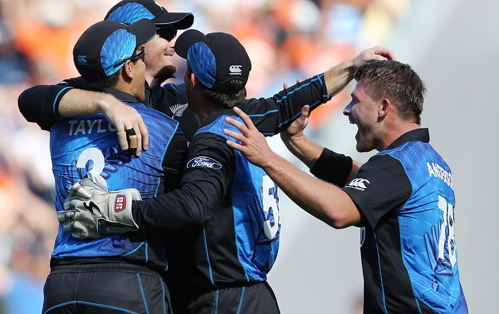 New Zealand’s Martin Guptill, second left, is congratulated by teammates after taking a catch to dismiss South Africa's Rilee Rossouw during their Cricket World Cup semifinal in Auckland, New Zealand.