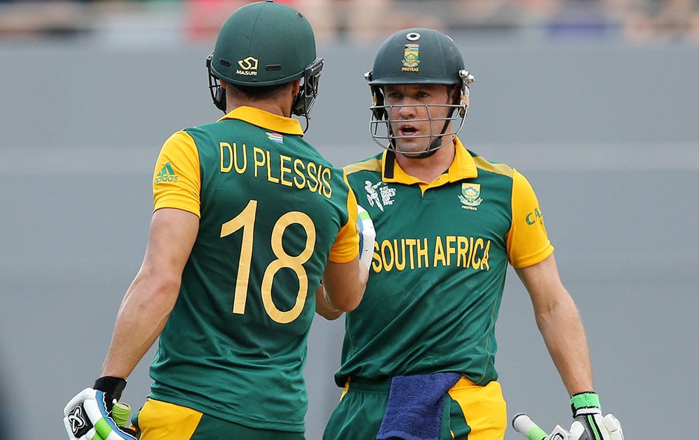 South Africa's AB de Villiers congratulates teammate Francois Du Plessis on his reaching 50 runs during their Cricket World Cup semifinal in Auckland, New Zealand.