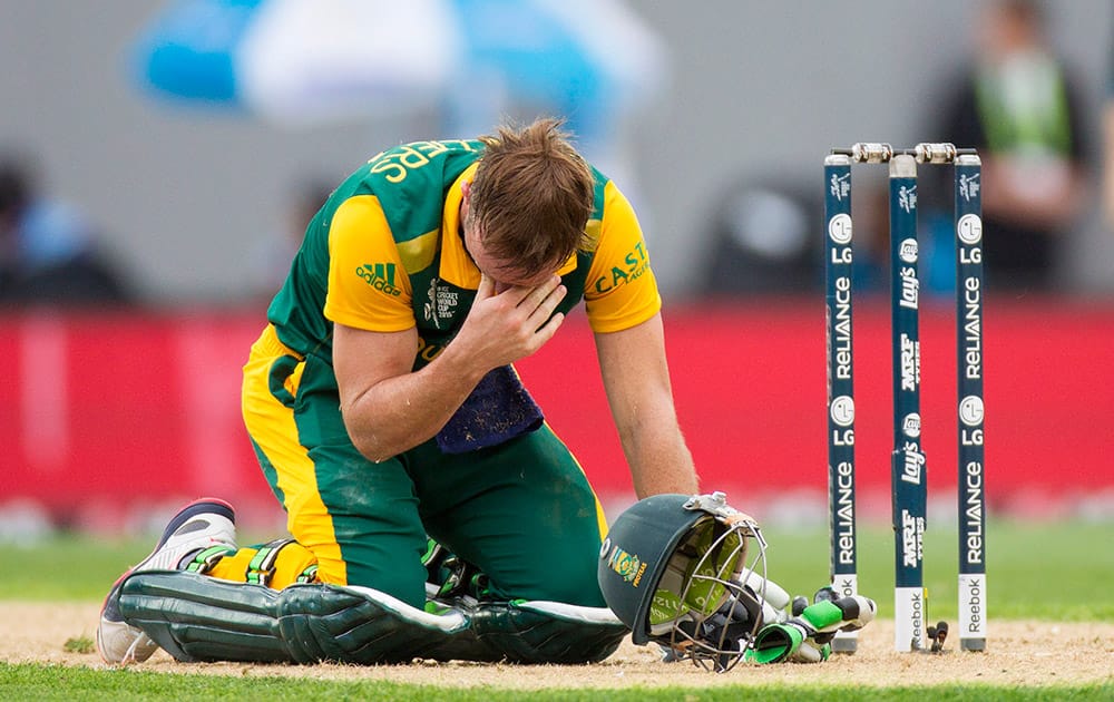 South Africa's AB de Villiers rests on the ground after getting dirt in his eyes while batting against New Zealand during their Cricket World Cup semifinal in Auckland, New Zealand.