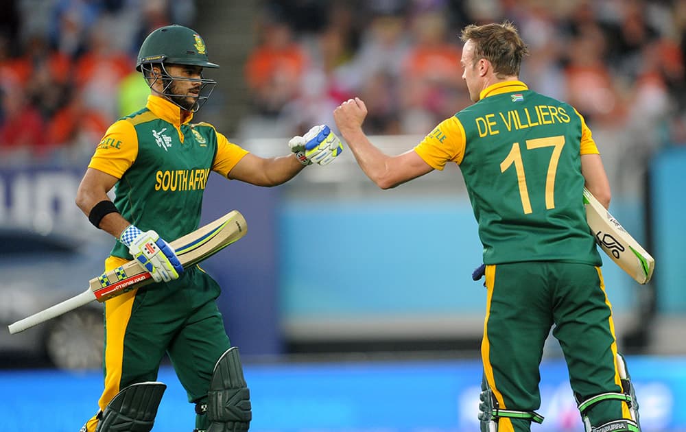 South Africa's AB de Villiers and JP Duminy celebrate after their innings against New Zealand during their Cricket World Cup semifinal in Auckland, New Zealand.