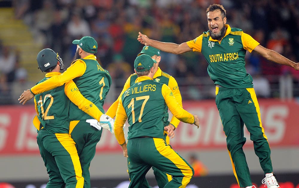 South African players celebrate the dismissal of New Zealand’s Martin Guptill after he was run out for 38 runs during their Cricket World Cup semifinal in Auckland, New Zealand.