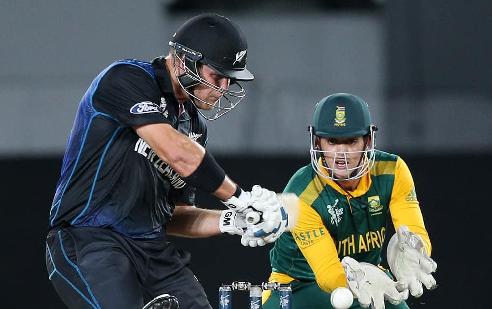 New Zealand’s Corey Anderson plays a shot as South African wicketkeeper Quinton De Kock watches during their Cricket World Cup semifinal in Auckland.