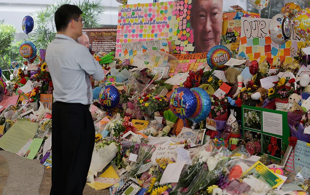 A man pays his respects at an area set aside for tributes to the late Lee Kuan Yew at the Singapore General Hospital, in Singapore.