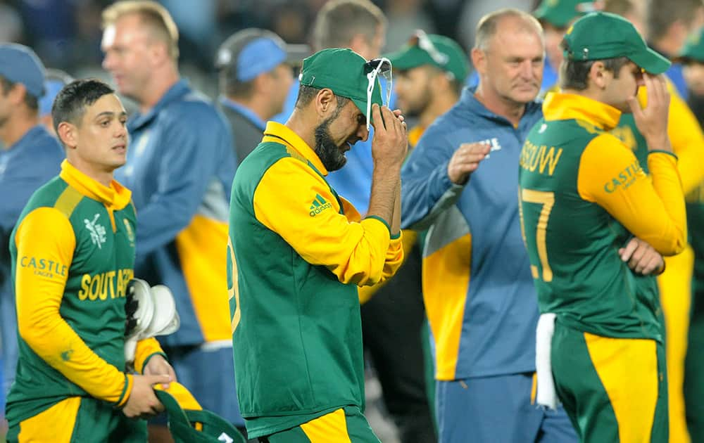 South Africa's Imran Tahir, reacts with his teammates following their four wicket loss to New Zealand in their Cricket World Cup semifinal in Auckland, New Zealand.