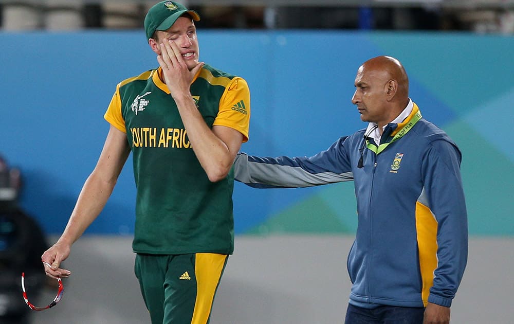 South Africa's Morne Morkel is consoled by teammate after their four wicket loss to New Zealand in their Cricket World Cup semifinal in Auckland, New Zealand.