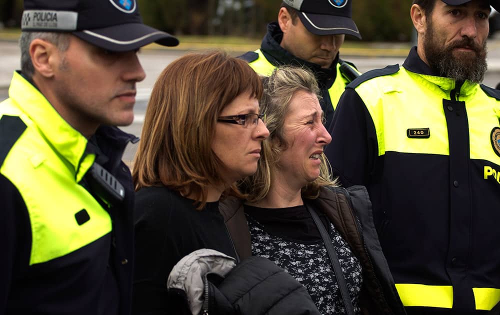 Family members of people involved in a crashed plane arrives at the Barcelona airport in Spain. A Germanwings passenger jet carrying more than 140 people crashed in the French Alps region as it traveled from Barcelona to Duesseldorf.