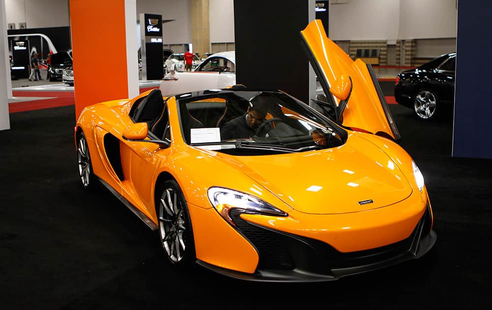 Isaac Villarreal parks a McLaren MSO 650S, which is priced starting at $280,225, in the High End section of the 2015 DFW Auto Show at the Kay Bailey Hutchinson Convention Center in Dallas.