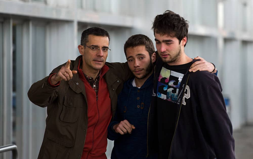 Family members of people involved in a crashed plane comfort each other as they arrive at the Barcelona airport in Spain.