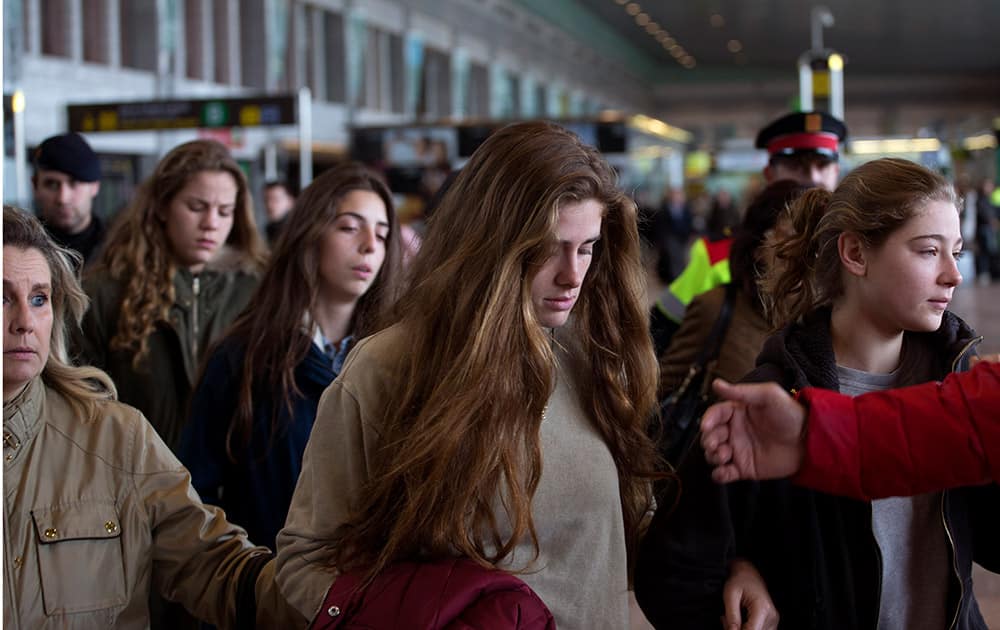 Unidentified family and friends of people involved in a crashed plane arrive at the Barcelona airport in Spain.