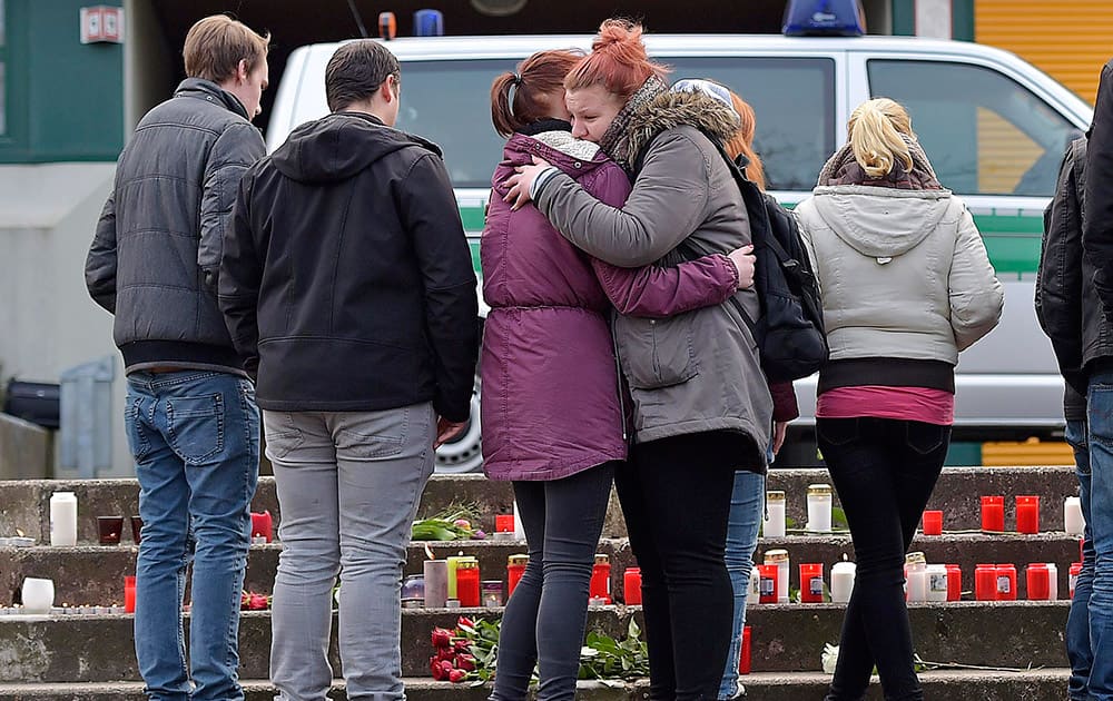 Two girls hug in front of the Joseph-Koenig-Gymnasium in Haltern, western Germany .