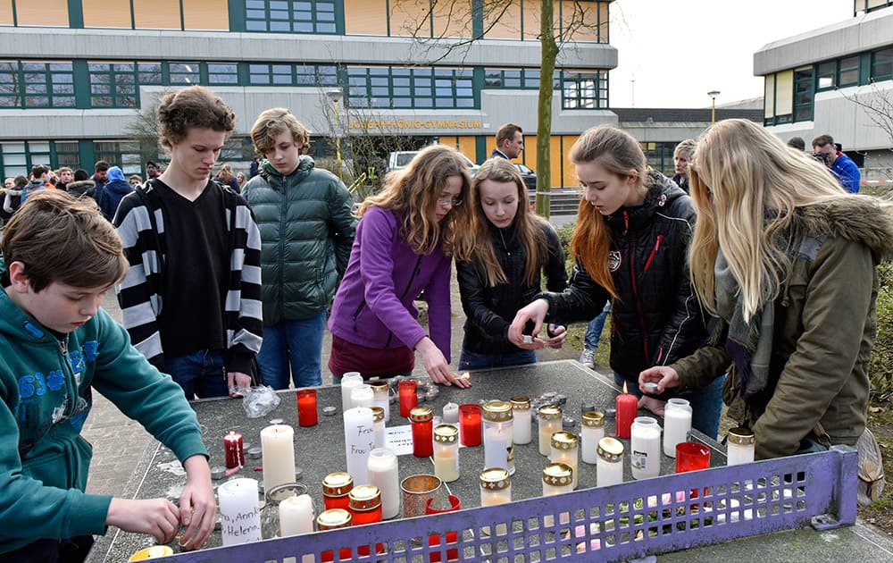 Students put candles on a table tennis table in front of the Joseph-Koenig Gymnasium in Haltern, western Germany.