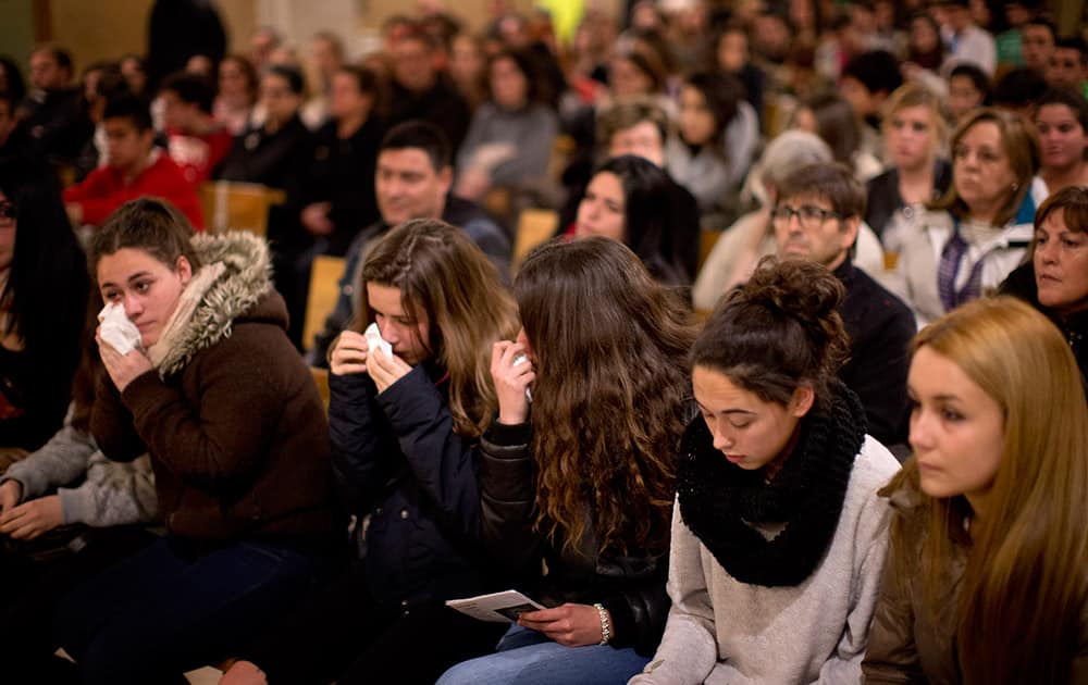 Friends of the German students from the crashed plane attend a mass in Llinars del Valles, near Barcelona, Spain.