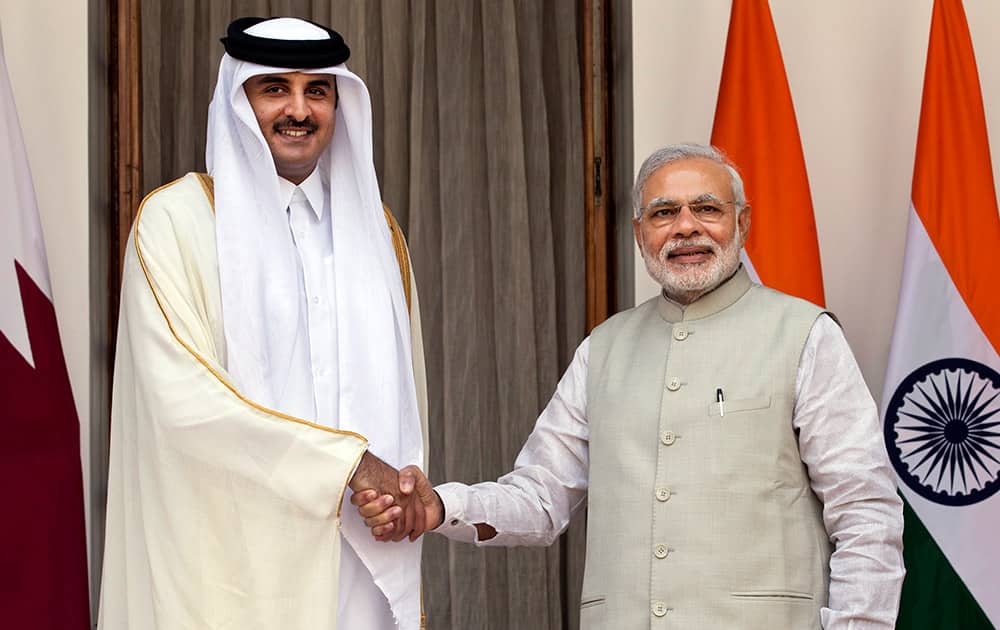 Qatar's Emir Sheikh Tamim bin Hamad Al-Thani and Narendra Modi, pose for a photograph in New Delhi.