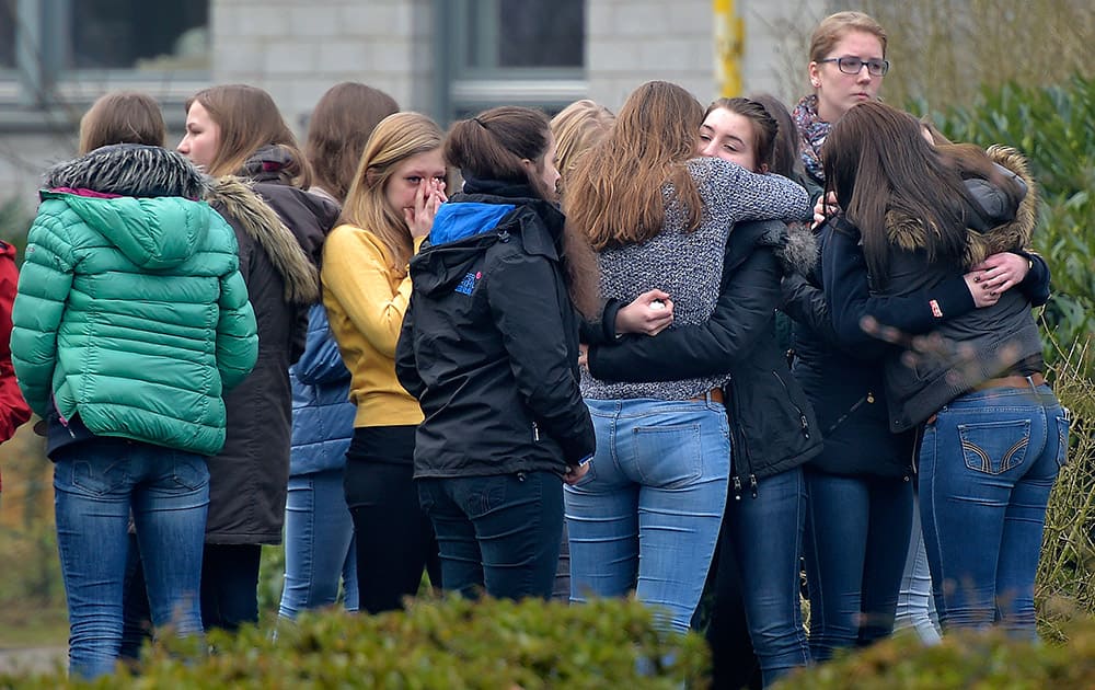 Students mourn in front of the Joseph-Koenig Gymnasium in Haltern, western Germany.