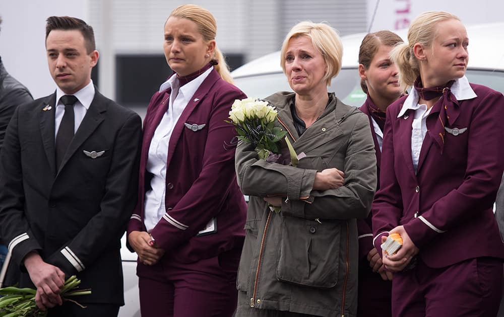 Employees of Germanwings mourn in front of the company's headquarters in Cologne, the day after a Germanwings aircraft , carrying 150 people, crashed in France on the way from Barcelona, Spain, to Duesseldorf, Germany.