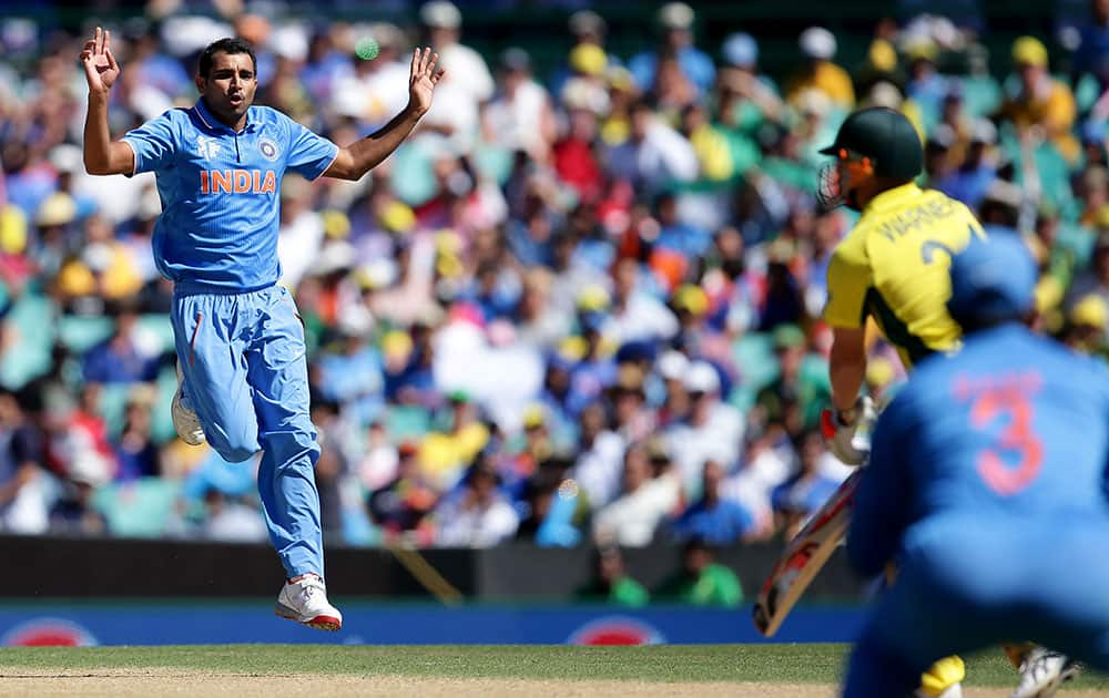 India's Mohammed Shami, left, reacts after bowling to Australia's Aaron Finch during their Cricket World Cup semifinal in Sydney, Australia.