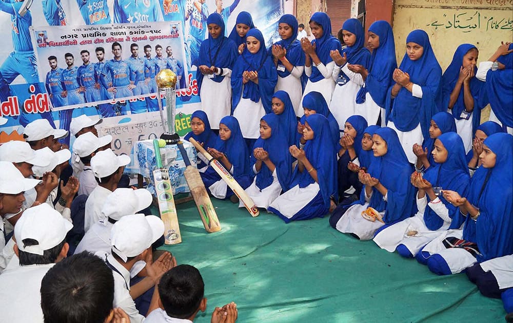 Muslim children pray for Team Indias victory ahead of the teams World Cup semifinal match against Australia, in Surat.