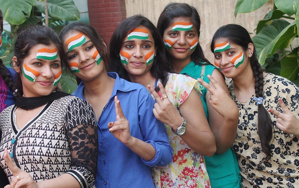 Cricket fans flash victory sign for the victory of Indian Cricket team against Australia in the semi final clash to be held in Sydney, in Faridabad.