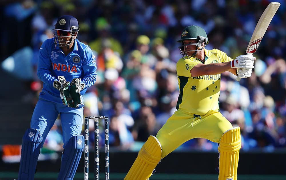 Australia's Aaron Finch plays a shot as India's MS Dhoni watches during their Cricket World Cup semifinal in Sydney.