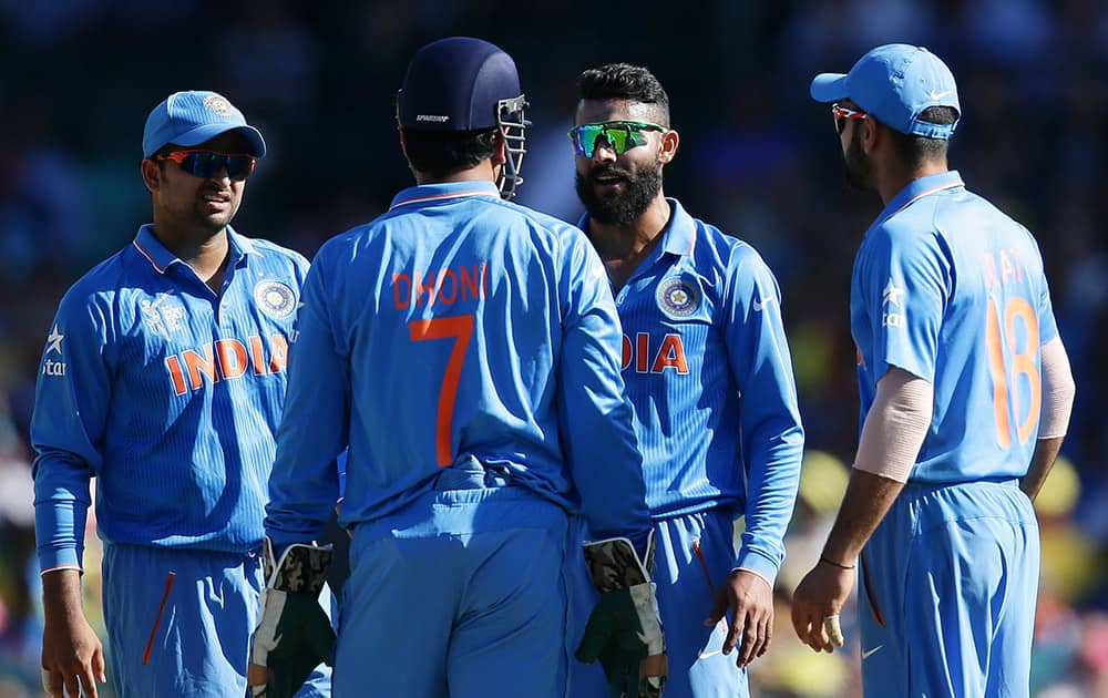 Ravindra Jadeja, talks with his captain India's MS Dhoni about calling for a video review of a LBW decision during their Cricket World Cup semifinal against Australia in Sydney, Australia.