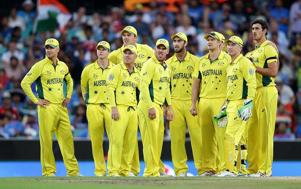 Australian players watch a giant screen as they review an appeal for a catch during their Cricket World Cup semifinal against India in Sydney.