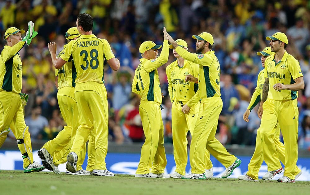 Australian players celebrate after taking the wicket of India's Shikhar Dhawan during their Cricket World Cup semifinal in Sydney.