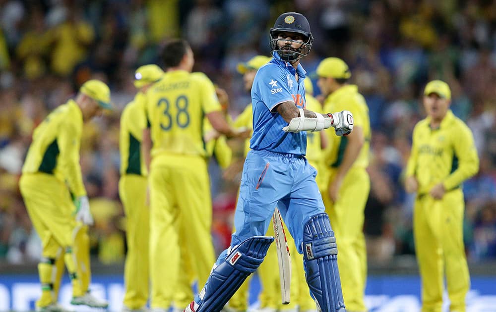 Shikhar Dhawan walks from the field after he was dismissed for 45 runs while batting against Australia during their Cricket World Cup semifinal in Sydney.