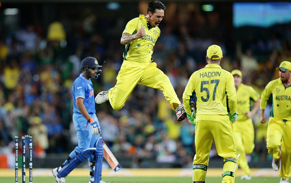 Australia's Mitchell Johnson leaps in the air as he celebrates after taking the wicket of India's Rohit Sharma, during their Cricket World Cup semifinal in Sydney, Australia.