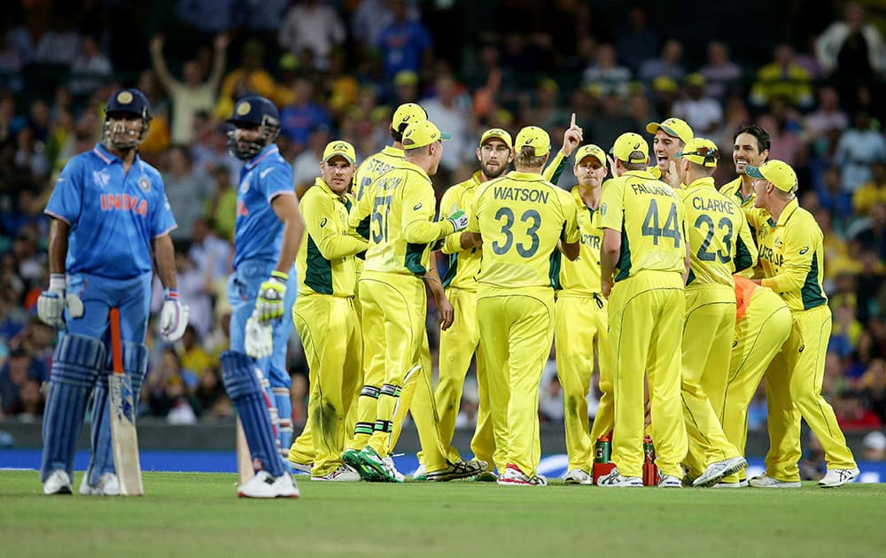 Australian players watch a video replay of the run out of India's Ravindra Jadeja during their Cricket World Cup semifinal in Sydney, Australia.