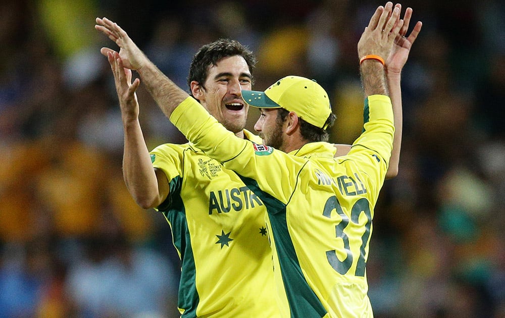 Australia's Glenn Maxwell is congratulated by teammate Mitchell Starc after running out India's MS Dhoni during their Cricket World Cup semifinal in Sydney, Australia.