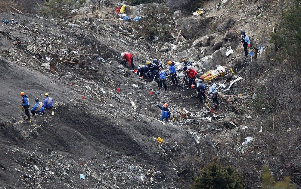 Rescue workers work on debris of the Germanwings jet at the crash site near Seyne-les-Alpes, France.