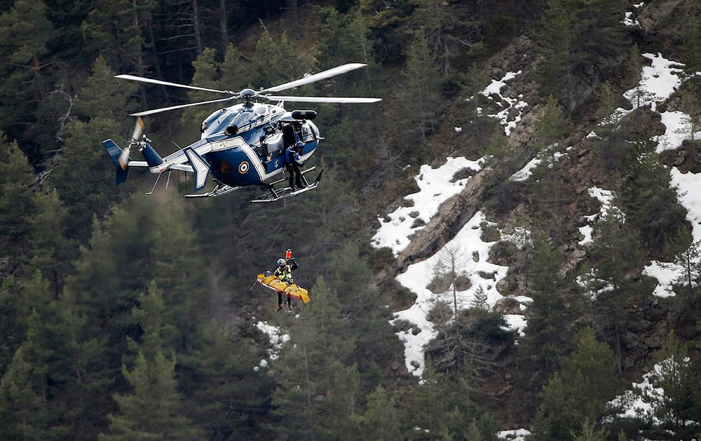 A rescue worker is lifted into an helicopter near the crash site near Seyne-les-Alpes, France.