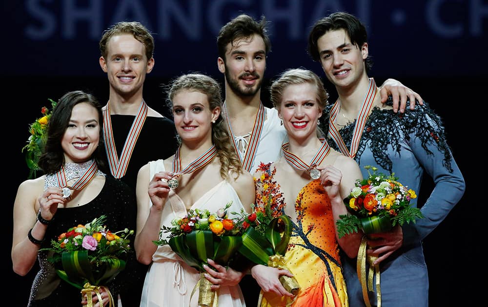 Posing with their medals for the Ice Dance Free Dance event; Gabriella Papadakis and Guillaume Cizeron of France with gold, Madison Chock and Evan Bates of the United States, with silver and Kaitlyn Weaver and Andrew Poje of Canada with bronze in the ISU World Figure Skating Championship 2015 held at the Oriental Sports Center in Shanghai, China.