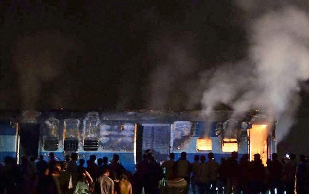 The sleeper class coach of Saket Express after it caught fire near Naini railway station in Allahabad.