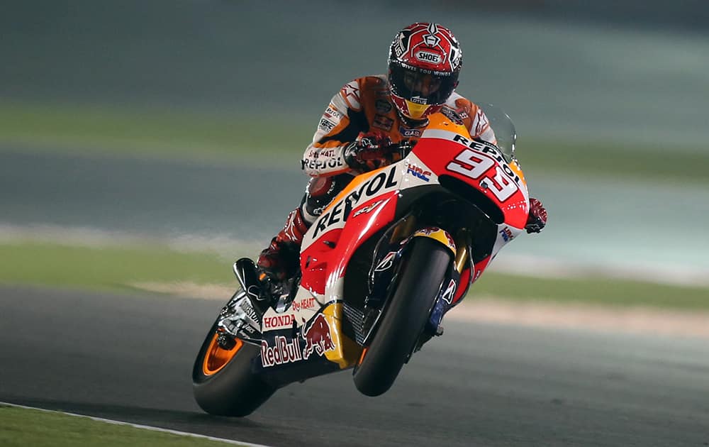 Spanish MotoGP rider Marc Marquez of the Repsol Honda Team performs a wheelie during a free practice at the Losail International Circuit in Doha, Qatar.