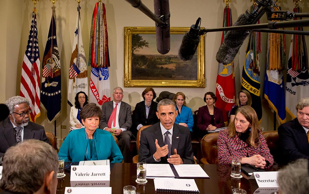 President Barack Obama, sitting between Senior Adviser Valerie Jarrett, left, and Health and Human Services Secretary Sylvia Burwell, talks about antibiotic-resistant bacteria as he meets with members of his Council of Advisers on Science and Technology, in the Roosevelt Room of the White House in Washington.