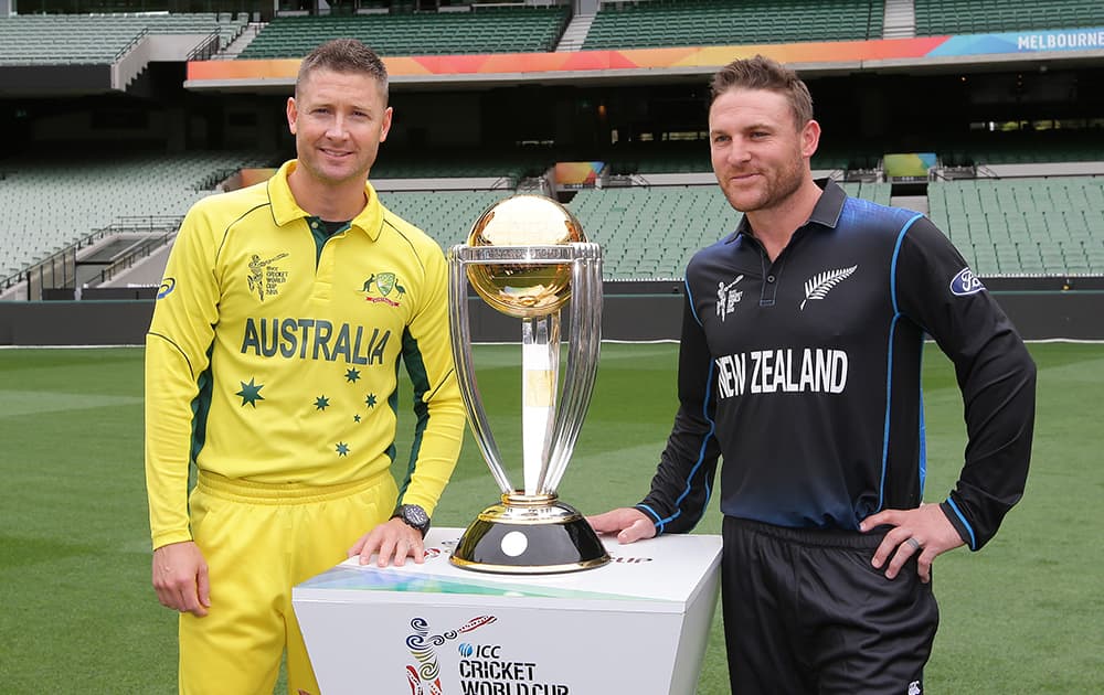 Australia's captain Michael Clarke and New Zealand’s captain Brendon McCullum pose for a photo with the Cricket World Cup trophy at the MCG in Melbourne, Australia.