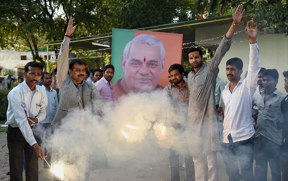 BJP workers celebrate after former Prime Minister Atal Bihari Vajpayee was conferred with Bharat Ratna, in Lucknow.