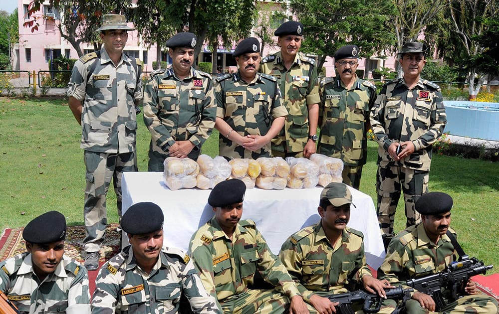 BSF officers showing 24 kilogram of heroin valued Rs 120 crore in international market, recovered from Smugglers in Amritsar.