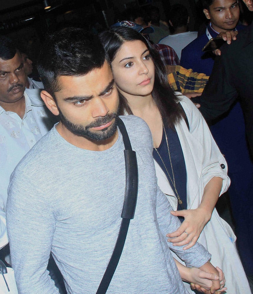 Virat Kohli and actress Anushka Sharma upon their arrival at the international airport in Mumbai.