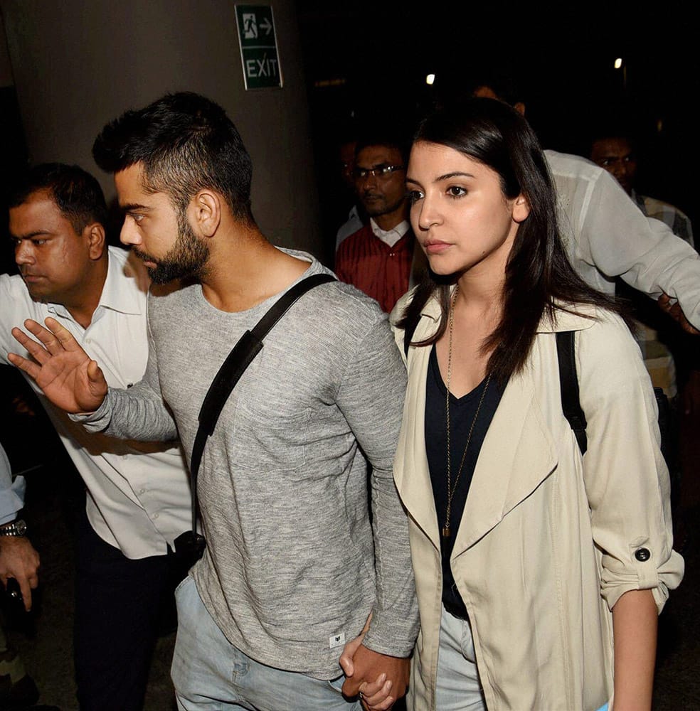 Virat Kohli and actress Anushka Sharma upon their arrival at the international airport in Mumbai.