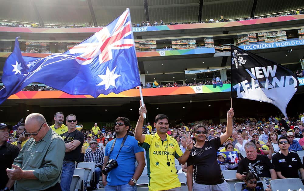 New Zealand and Australia supporters wave their flags ahead of the Cricket World Cup final in Melbourne, Australia.