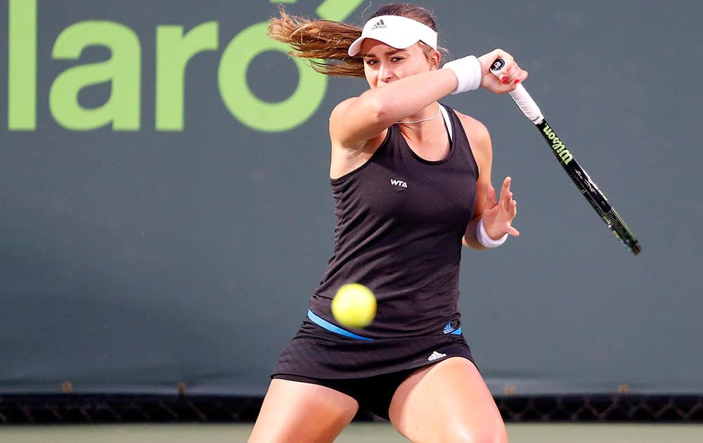 Paula Badosa Gibert, of Spain, returns the ball to Karolina Pliskova, of the Czech Republic, at the Miami Open tennis tournament in Key Biscayne, Fla.