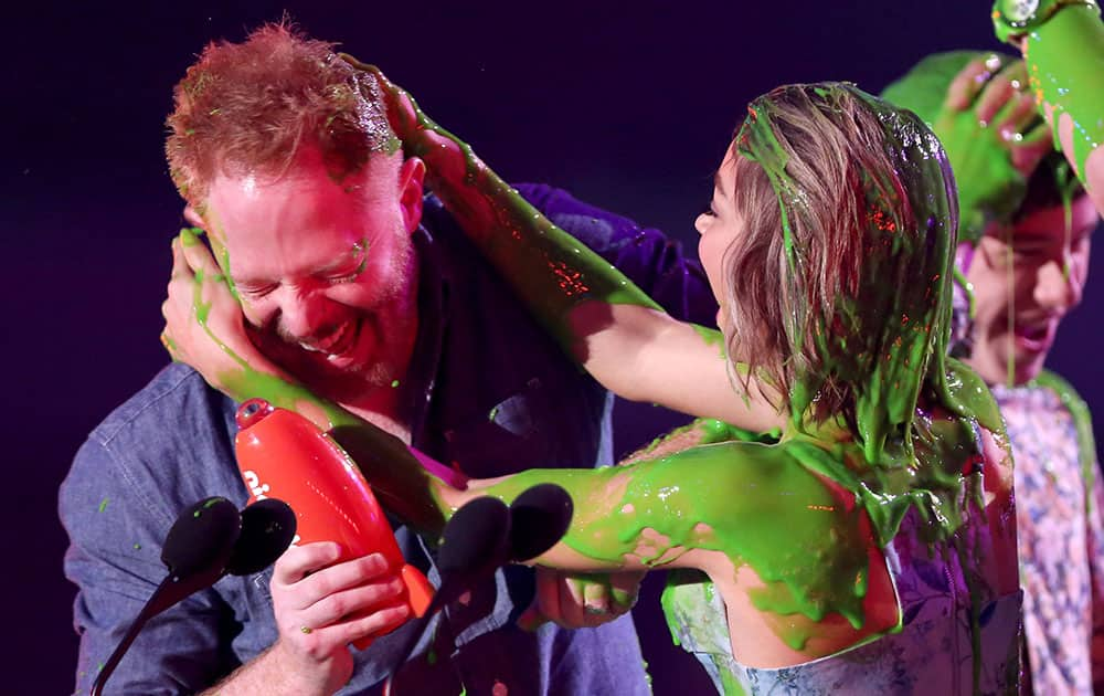 Jesse Tyler Ferguson, left, and Sarah Hyland are slimed after being announced winners of the award for favorite family TV show for “Modern Family” at Nickelodeon's 28th annual Kids' Choice Awards at The Forum, in Inglewood, Calif.