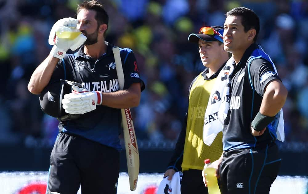 New Zealand’s Grant Elliott and Ross Taylor, right, watch a video review during the Cricket World Cup final against Australia in Melbourne, Australia.