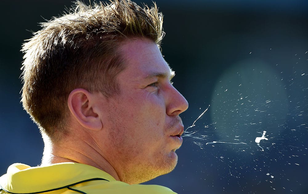 Australia's James Faulkner spits while fielding during the Cricket World Cup final against New Zealand in Melbourne, Australia.