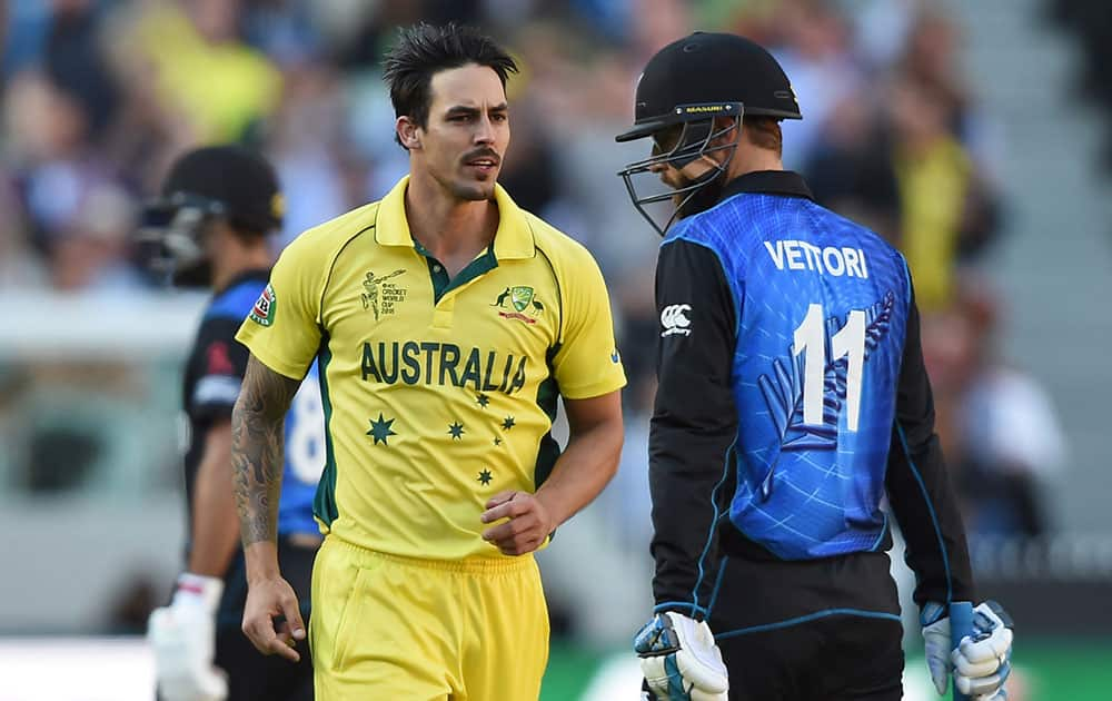 Australia's Mitchell Johnson runs past New Zealand’s Daniel Vettori after dismissing him during the ICC Cricket World Cup final in Melbourne, Australia.