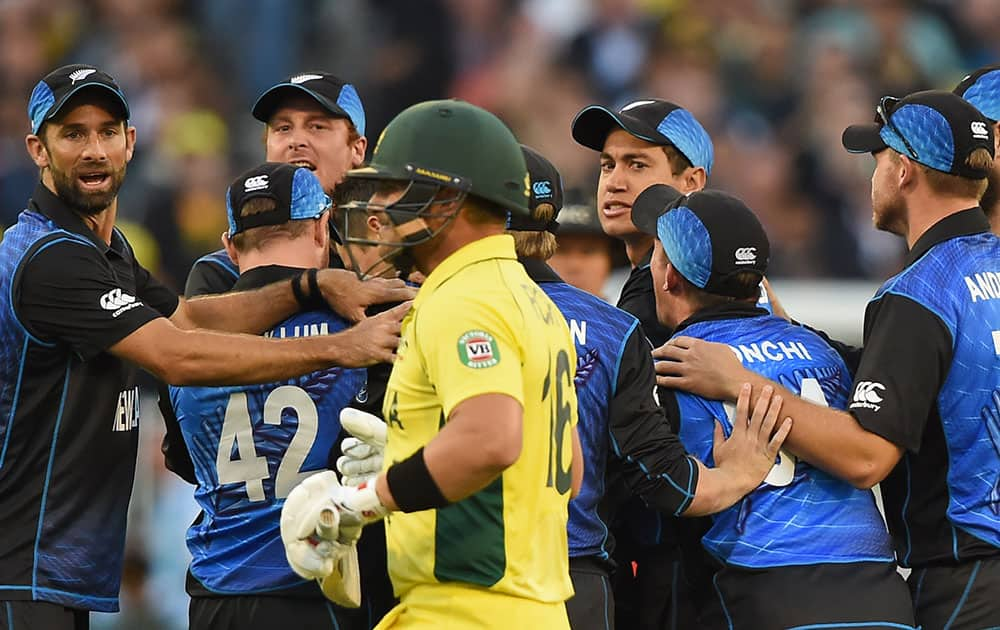 New Zealan's cricketers watch Australia's Aaron Finch walk off the field after being dismissed during the ICC Cricket World Cup final in Melbourne, Australia.