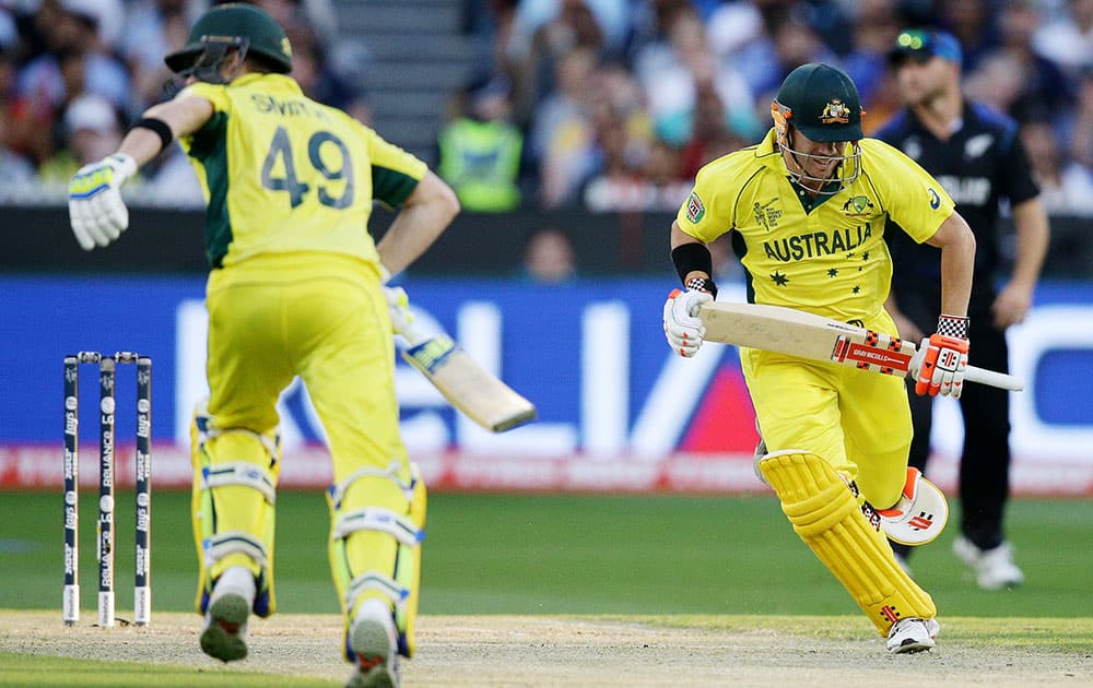 Australia's David Warner, right, and Steve Smith run between the wickets during the Cricket World Cup final against New Zealand in Melbourne, Australia.